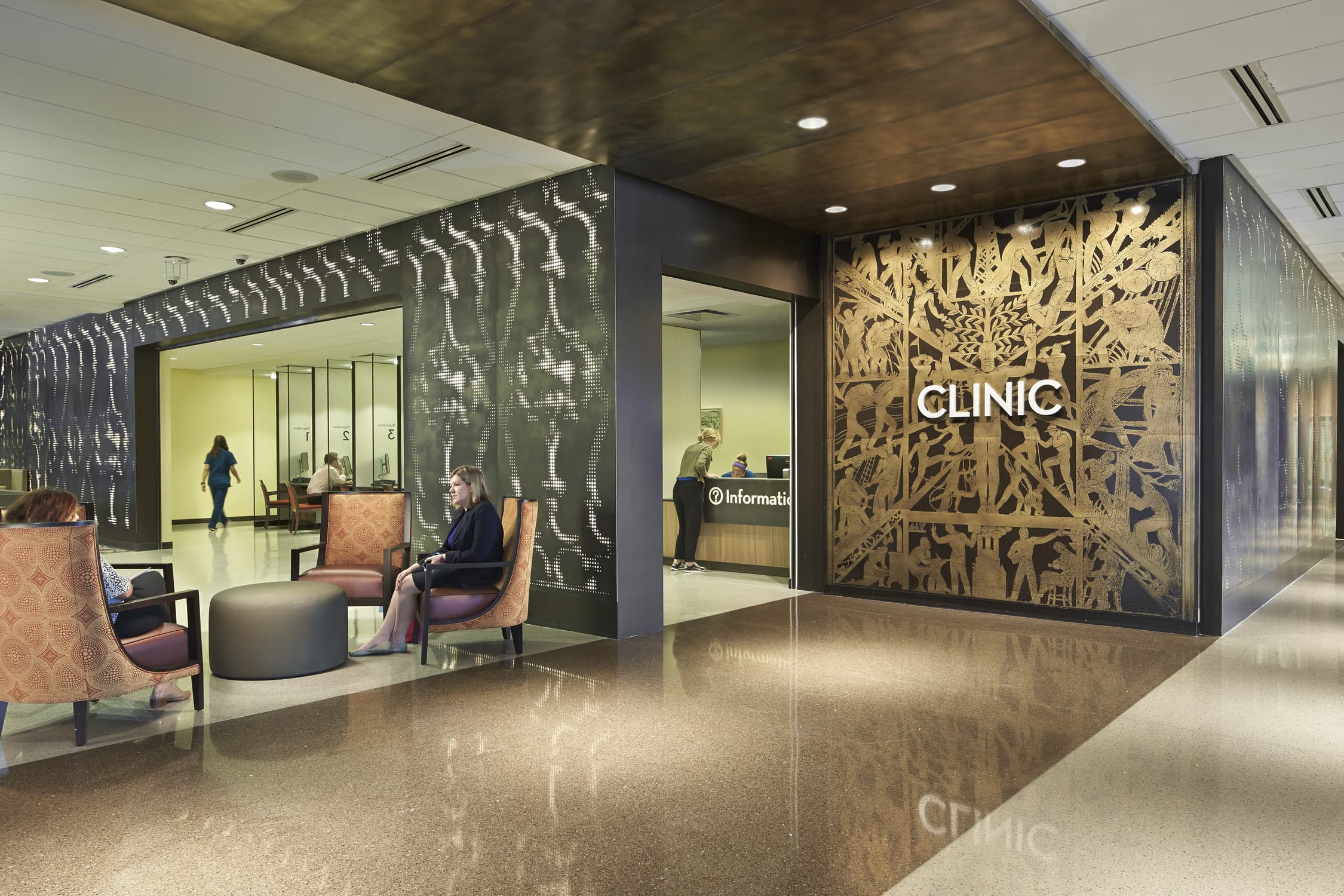 The clinic's reception area is demarcated by a wall graphic of the frieze that marked the main entrance of Charity Hospital, which was shuttered after Hurricane Katrina.
