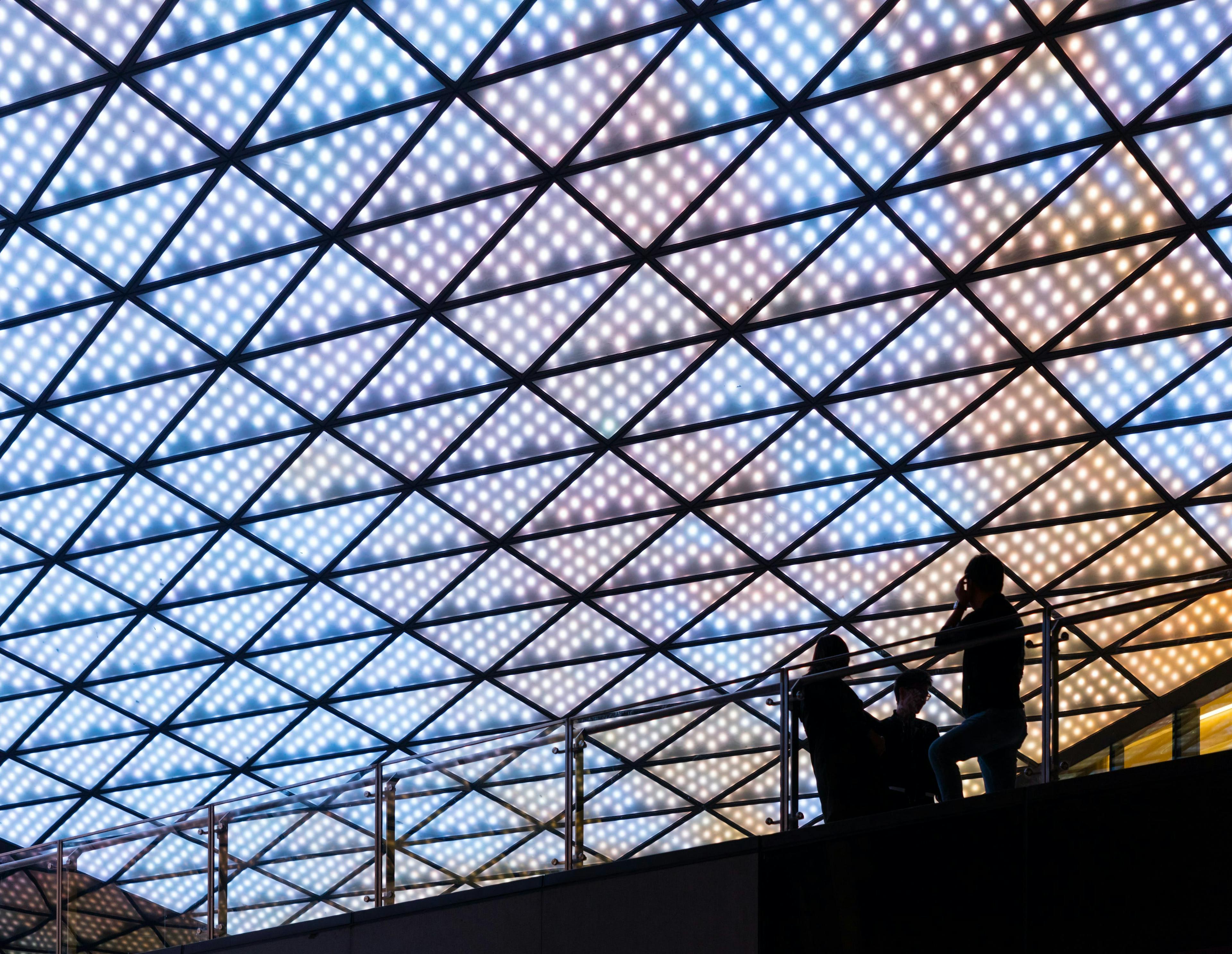 silhouettes under a lit ceiling